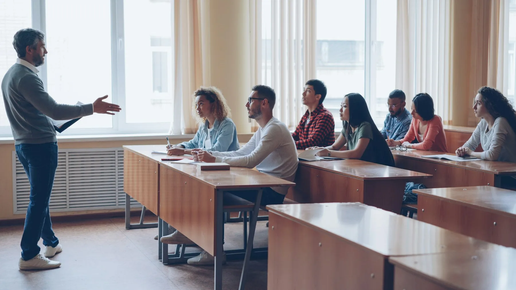 An instructor leading a lesson for adult learners in a classroom